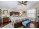 Comfortable main bedroom with large bed, ceiling fan, and natural light at 17324 Se 82Nd Pecan Ter, The Villages, FL 32162