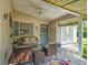 Inviting covered patio with wicker furniture, ceiling fan, and charming decor at 17324 Se 82Nd Pecan Ter, The Villages, FL 32162