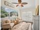 Bright sunroom featuring comfortable seating, natural light and view to the outside at 17324 Se 82Nd Pecan Ter, The Villages, FL 32162