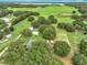 Aerial view of the neighborhood highlighting the pool, pond and surrounding area at 17670 Se 283Rd Ave, Umatilla, FL 32784
