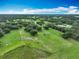 Expansive aerial view of the land featuring lush green pastures and mature trees at 17670 Se 283Rd Ave, Umatilla, FL 32784