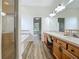 Well-lit bathroom showcasing a walk-in shower, tub, and double sinks, offering functionality and comfort at 17670 Se 283Rd Ave, Umatilla, FL 32784