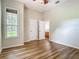 Relaxing bedroom with wood-look flooring and great natural light from the large window at 17670 Se 283Rd Ave, Umatilla, FL 32784