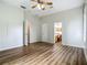 Spacious bedroom showcasing wood-look flooring and views to other living areas and natural light at 17670 Se 283Rd Ave, Umatilla, FL 32784
