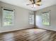 Bedroom with wood-look flooring and multiple windows providing lots of natural light and outdoor views at 17670 Se 283Rd Ave, Umatilla, FL 32784