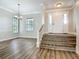 Bright foyer with hardwood flooring, a chandelier, and staircase leading to the upper level at 17670 Se 283Rd Ave, Umatilla, FL 32784