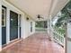 Charming front porch with tiled floor, ceiling fan and white picket railing at 17670 Se 283Rd Ave, Umatilla, FL 32784