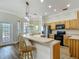 Beautiful kitchen with wood cabinets, stainless steel appliances, and breakfast bar with seating at 17670 Se 283Rd Ave, Umatilla, FL 32784