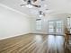 Spacious living room featuring wood flooring and double doors leading to the outdoor area at 17670 Se 283Rd Ave, Umatilla, FL 32784