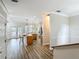 Open living space with hardwood floors seamlessly connecting the living, kitchen, and dining areas at 17670 Se 283Rd Ave, Umatilla, FL 32784