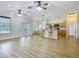 Open living area with hardwood floors, ceiling fans, and a breakfast bar connecting to the kitchen at 17670 Se 283Rd Ave, Umatilla, FL 32784