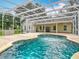 Inviting in-ground screened pool with water features and views of the backyard and surrounding property at 17670 Se 283Rd Ave, Umatilla, FL 32784