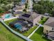 Aerial view of a property with a screened pool, solar panels, and fenced backyard at 1861 Remembrance Ave, St Cloud, FL 34769