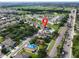 Aerial view features property with a pool, solar panels, and nearby streets, marked with a pin at 1861 Remembrance Ave, St Cloud, FL 34769
