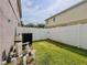 Backyard with a privacy fence, utility equipment, and a patch of green grass at 1861 Remembrance Ave, St Cloud, FL 34769