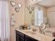 Bathroom vanity with decorative mirrors, neutral marble countertop, and stainless steel faucet at 1861 Remembrance Ave, St Cloud, FL 34769