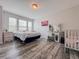 Bright bedroom with hardwood floors, a large bed, and a vanity area at 1861 Remembrance Ave, St Cloud, FL 34769