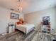 Charming bedroom featuring hardwood floors and a cozy bed with a decorative chandelier at 1861 Remembrance Ave, St Cloud, FL 34769