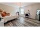 Comfortable bedroom featuring stylish decor, hardwood floors, and a window at 1861 Remembrance Ave, St Cloud, FL 34769