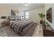 Well-lit bedroom with contemporary decor, plank floors and stylish gray furniture at 1861 Remembrance Ave, St Cloud, FL 34769