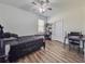 Bedroom with wood-look flooring, ceiling fan, and natural light from the window at 1861 Remembrance Ave, St Cloud, FL 34769