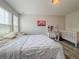 Cozy bedroom with hardwood floors, a bed, desk, and crib at 1861 Remembrance Ave, St Cloud, FL 34769