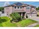 Two-story home with a well-manicured lawn and three car garage at 1861 Remembrance Ave, St Cloud, FL 34769