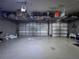 Two-car garage featuring overhead storage, providing ample space for parking and organization at 1861 Remembrance Ave, St Cloud, FL 34769