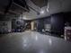 Garage interior featuring black accent wall, overhead storage, and ample space for gym equipment at 1861 Remembrance Ave, St Cloud, FL 34769