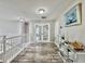 Well-lit hallway featuring a chandelier and staircase with decorative accents at 1861 Remembrance Ave, St Cloud, FL 34769