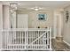 Hallway area with a white railing, chandelier, and modern flooring at 1861 Remembrance Ave, St Cloud, FL 34769