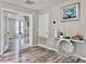 Hallway with wood floors, decorative table and white French doors at 1861 Remembrance Ave, St Cloud, FL 34769
