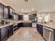 Modern kitchen featuring dark cabinets, granite countertops, and stainless steel appliances at 1861 Remembrance Ave, St Cloud, FL 34769