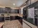Modern kitchen featuring dark wood cabinets and stainless steel appliances at 1861 Remembrance Ave, St Cloud, FL 34769