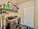 Laundry room featuring a modern washer and dryer set with storage shelves at 1861 Remembrance Ave, St Cloud, FL 34769