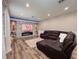 Living room featuring an electric fireplace and a large leather sectional at 1861 Remembrance Ave, St Cloud, FL 34769