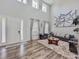 Spacious living room with high ceilings, large windows, and modern decor creates a welcoming atmosphere at 1861 Remembrance Ave, St Cloud, FL 34769