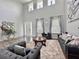 Bright living room featuring soaring ceilings, stylish decor, and comfortable seating area at 1861 Remembrance Ave, St Cloud, FL 34769