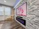 Living room highlighting a modern stone accent wall with a built-in electric fireplace at 1861 Remembrance Ave, St Cloud, FL 34769