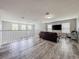 Loft with wood-look floors, comfortable seating, and plenty of natural light from the windows at 1861 Remembrance Ave, St Cloud, FL 34769
