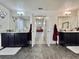 Bright main bathroom features double vanity, tile floors, and door to the bedroom at 1861 Remembrance Ave, St Cloud, FL 34769