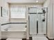Main bathroom features bathtub and glass-enclosed shower with dark tile accent at 1861 Remembrance Ave, St Cloud, FL 34769