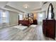 Spacious main bedroom with tray ceilings, wood floors and elegant four-poster bed at 1861 Remembrance Ave, St Cloud, FL 34769