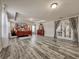 Spacious main bedroom with a four-poster bed, wood floors, and ample natural light at 1861 Remembrance Ave, St Cloud, FL 34769