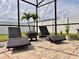 Pool deck with wicker lounge chairs, a fire pit, and lush green foliage at 1861 Remembrance Ave, St Cloud, FL 34769