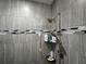 Close-up of tiled shower with modern fixtures and mosaic tile accent at 1861 Remembrance Ave, St Cloud, FL 34769