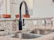 Close-up of a modern kitchen sink with a granite countertop at 1861 Remembrance Ave, St Cloud, FL 34769