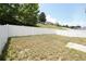 Spacious back yard featuring a white vinyl fence and sloping hill at 2007 Country Brook Ave, Clermont, FL 34711