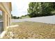 View of the spacious backyard featuring a white fence and view of home at 2007 Country Brook Ave, Clermont, FL 34711