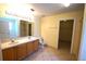 Bathroom featuring double vanity, tiled floors, and open shower area at 2007 Country Brook Ave, Clermont, FL 34711